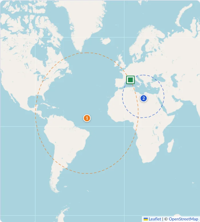 World map: a large orange circle around a point in the middle of the Atlantic and a smaller blue circle around a point in Libya meet in the western Mediterranean, at a green square.